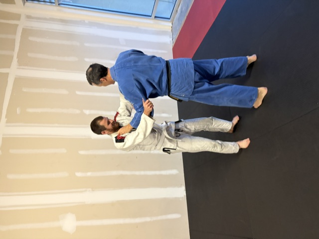 Judo instructor Mike teaching a beginner at Brevard Judo Academy