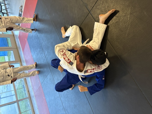 Student attempting Kesa Gatame during class.